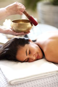 diverse-masseuse-and-client-during-sound-therapy-V5SZ2AN.jpg
